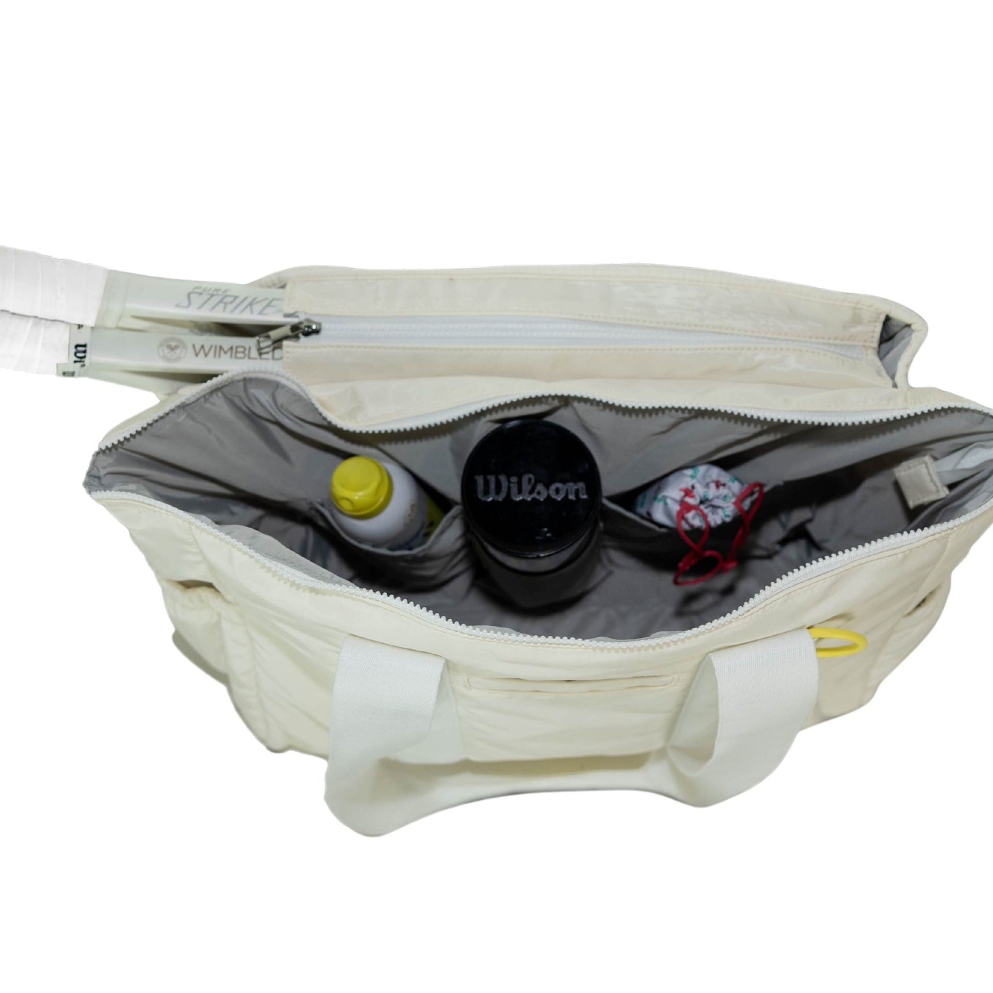 Open white sports bag with tennis equipment inside on a white background