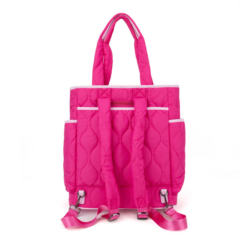 Pink quilted tennis tote bag with multiple compartments on a white background