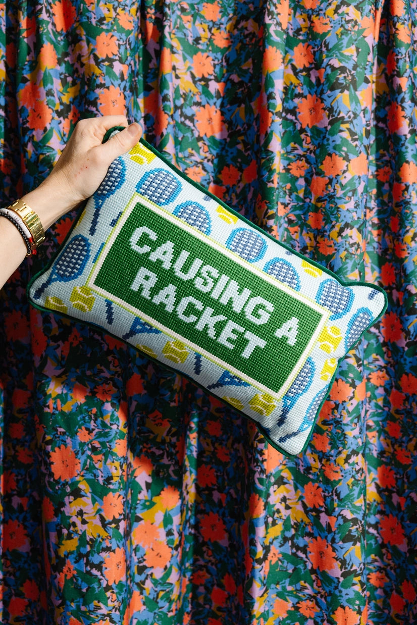 woman holding Furbish Causing a Racket Tennis Pillow on TennisDuJour.com