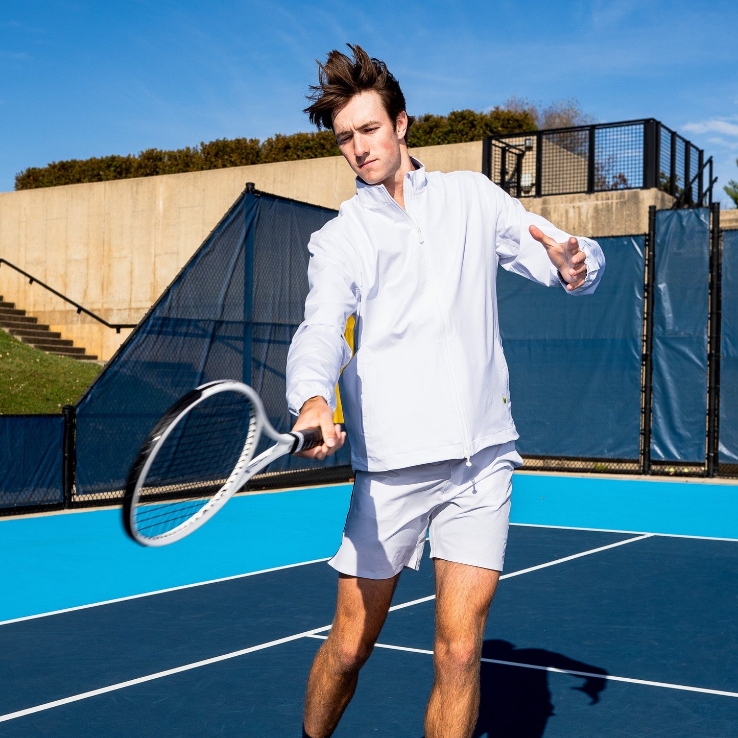 Male tennis player wearing Sigrún match tennis jacket in white on tennisdujour.com