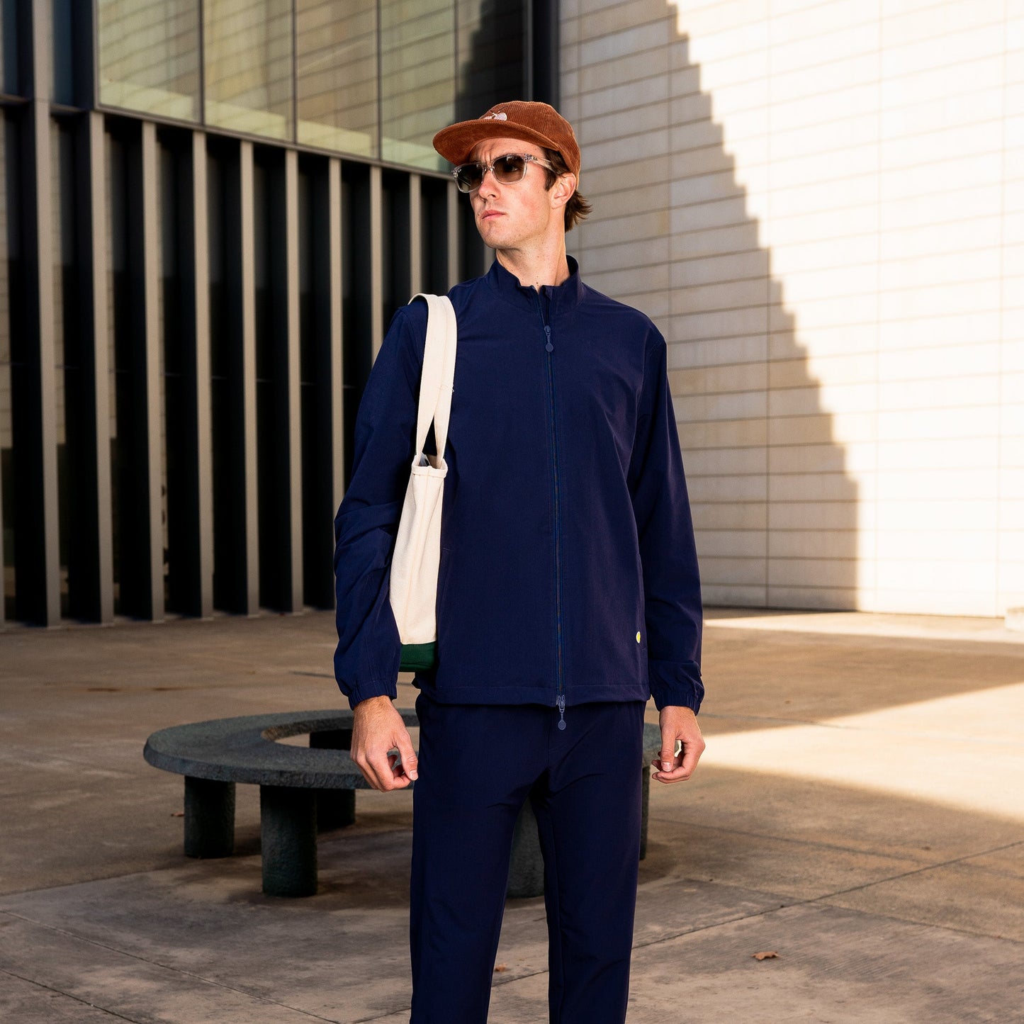 Model wearing Sigrún tennis jacket in navy.