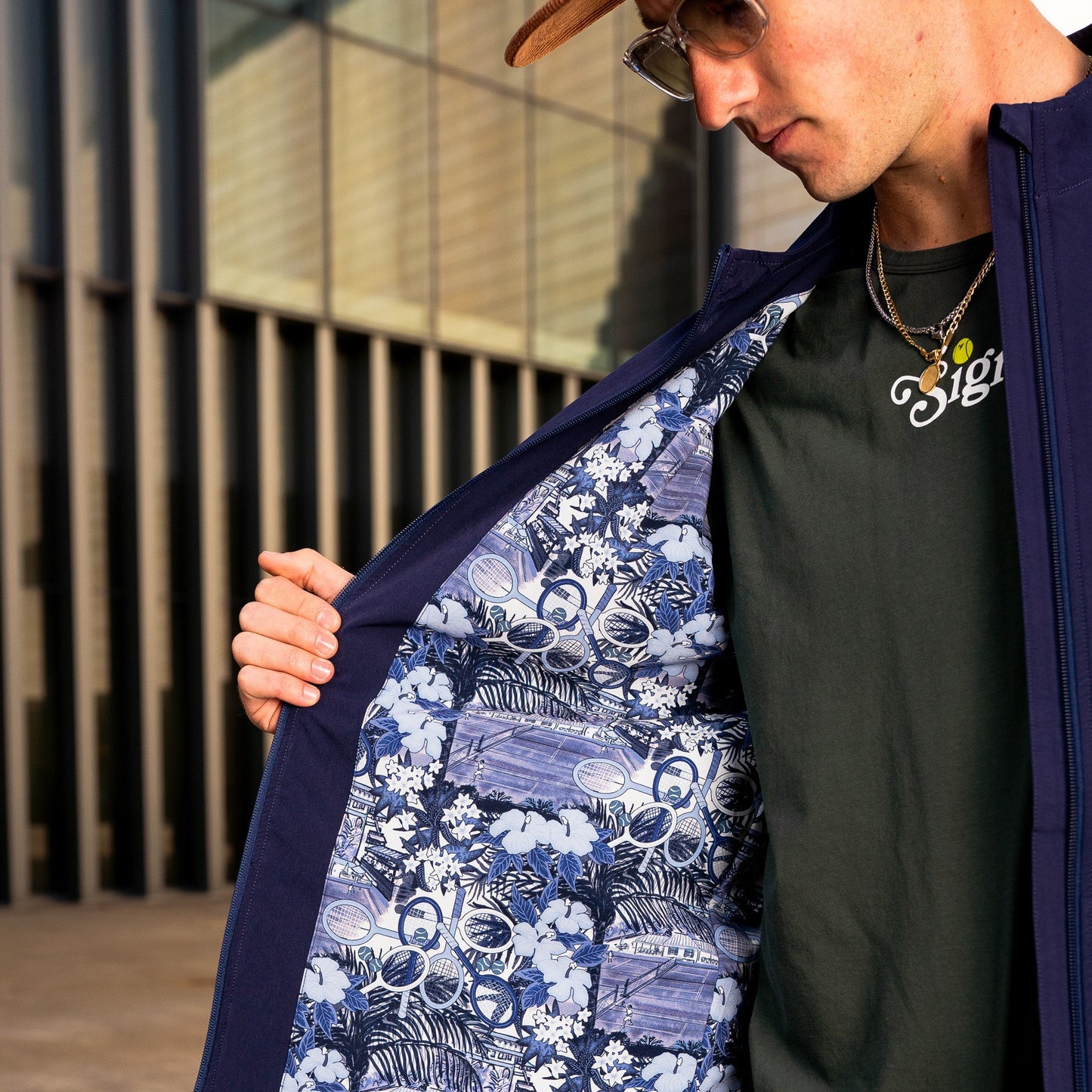 Model wearing Sigrún navy match tennis jacket showing inside panel.