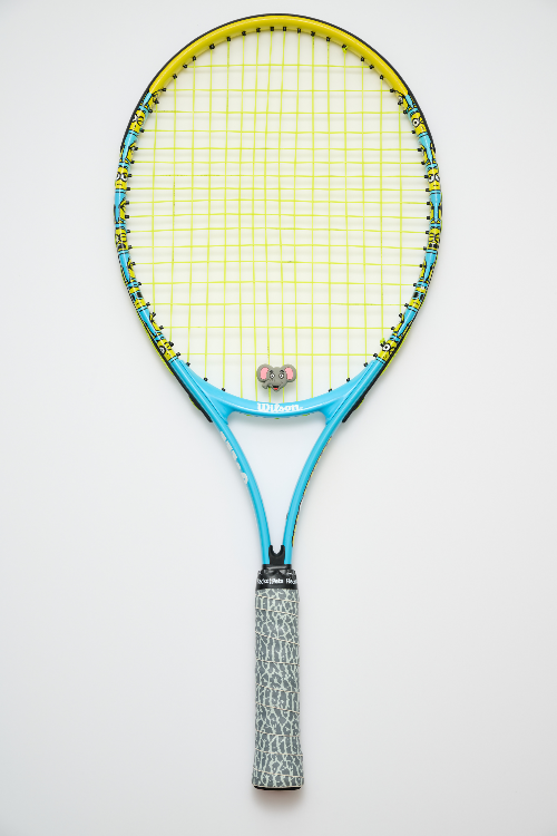 Tennis racket with a white strings and blue frame on a light gray background
