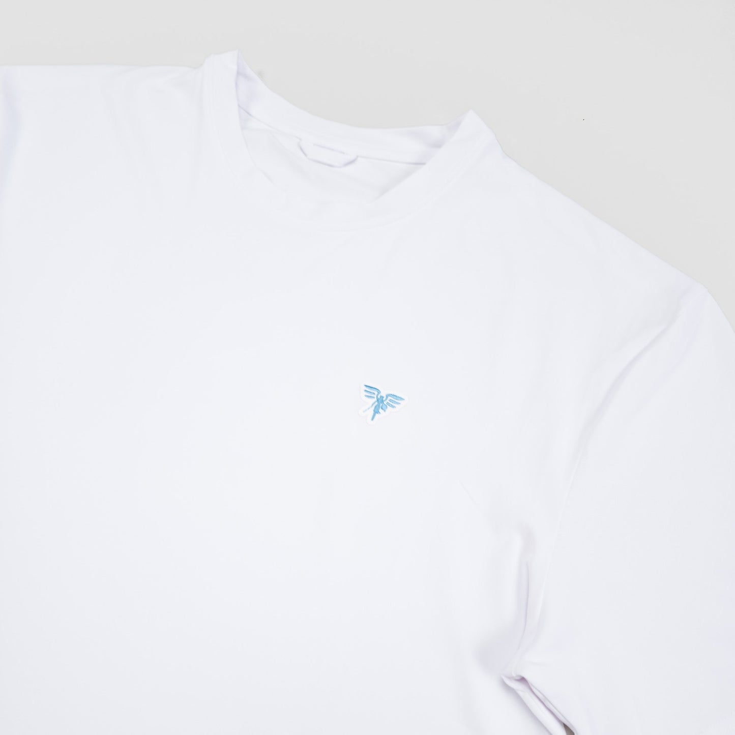 Sigrún white match tee with light blue logo.