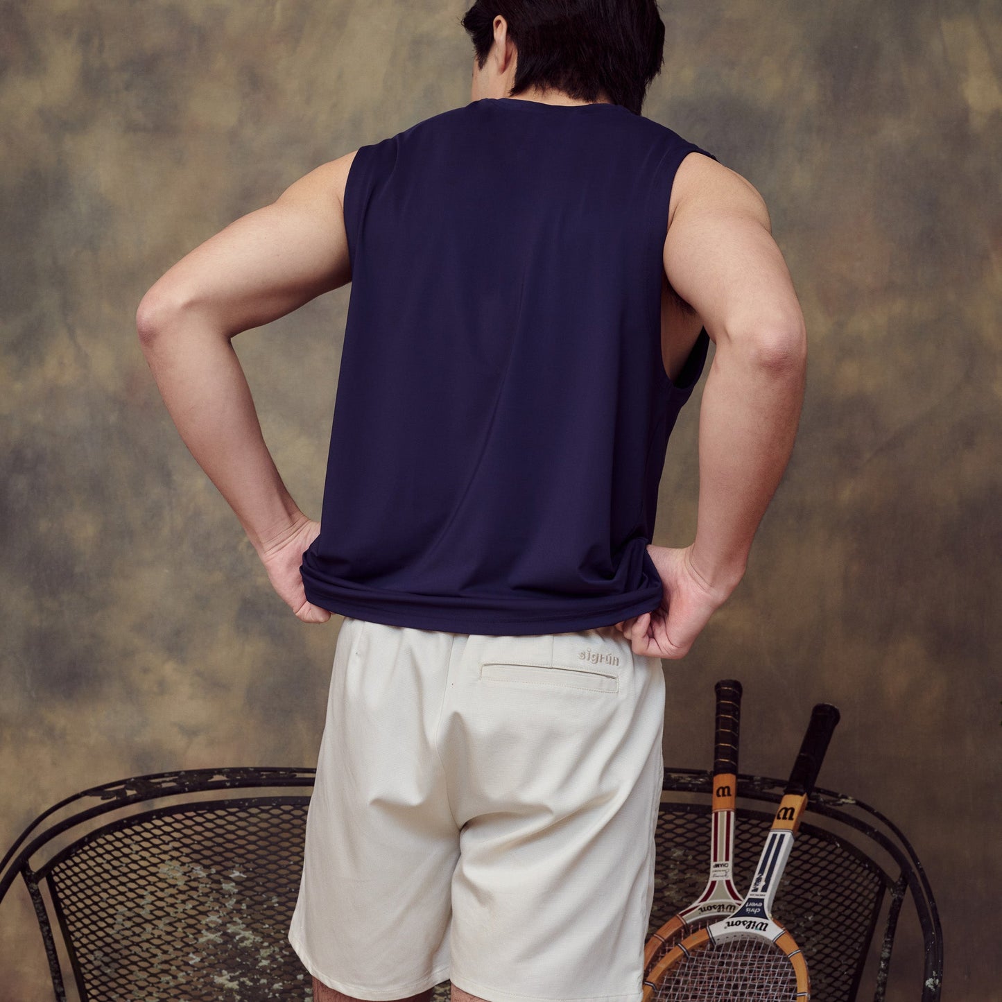Model wearing Sigrún men's navy tank back view.