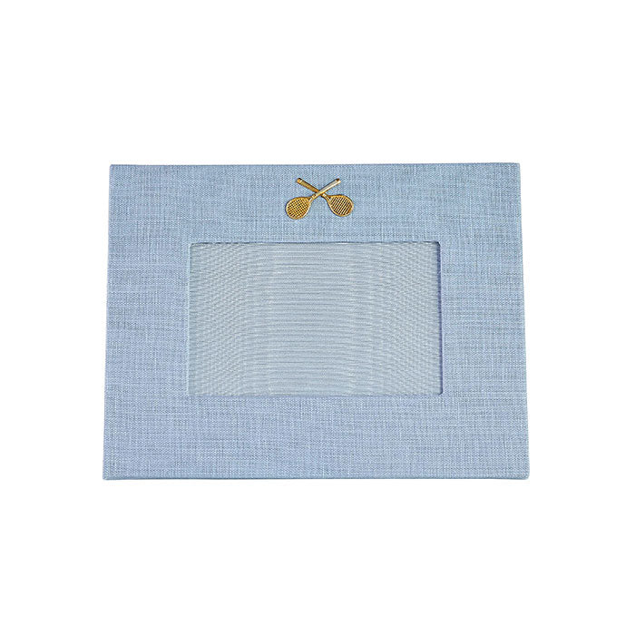 Light blue linen picture with gold medallion of crossed tennis racquets on Tennis DuJour.