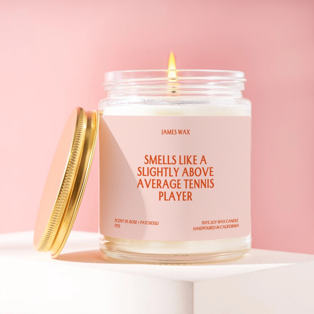 Burning candle with "Smells Like a slightly above average tennis player" on the label.