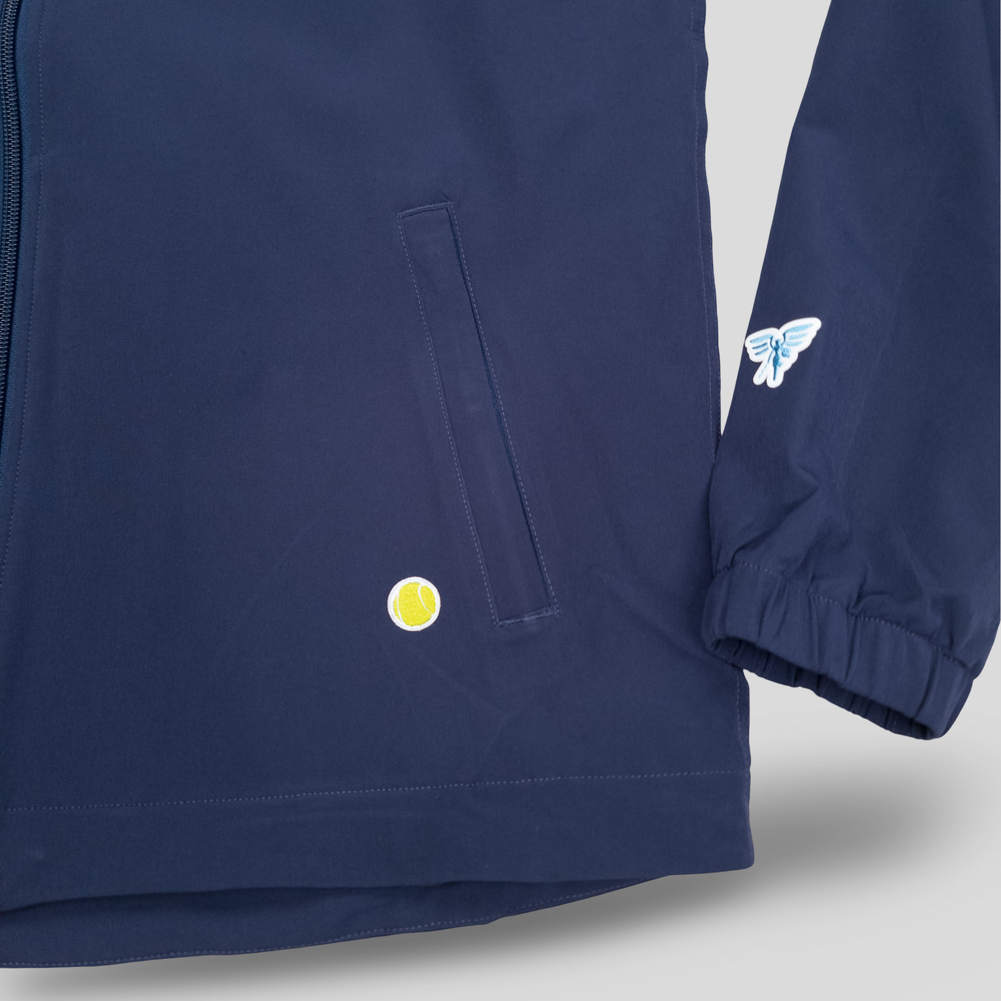 Sigrún match tennis jacket in navy with tennis ball imprinted.