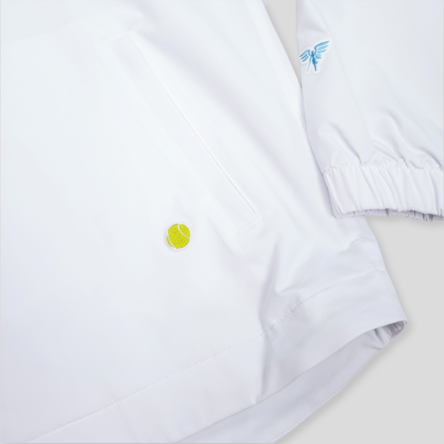 Sigrún match tennis jacket with close up of tennis ball on lower half.