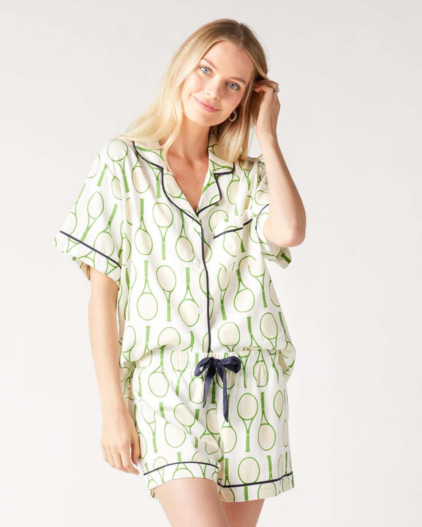 Woman wearing a green and white patterned nightshirt on a white background