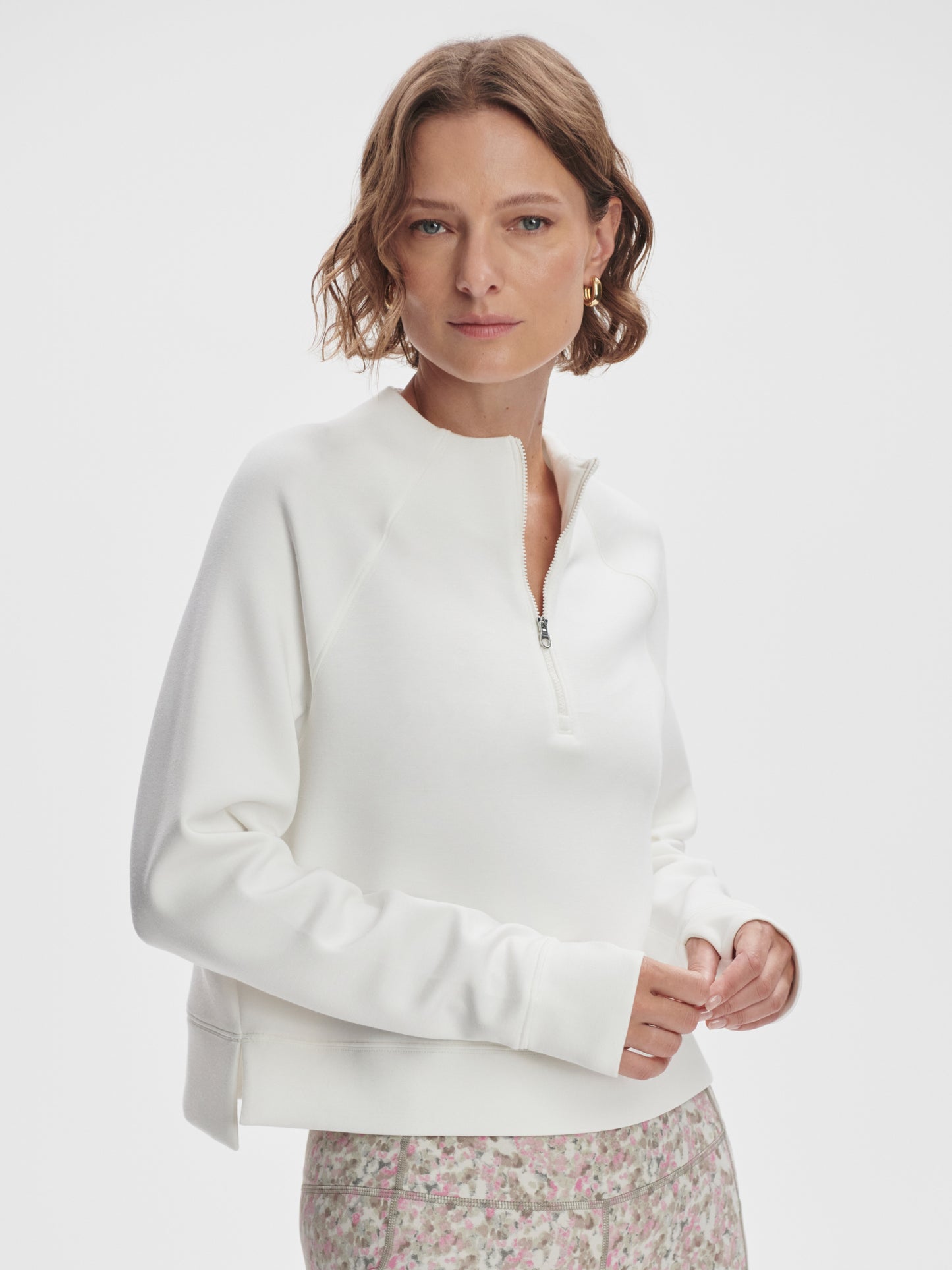 Model wearing Varley Ebba Halfzip MidLayer top in Snow White on TennisDuJour.com.