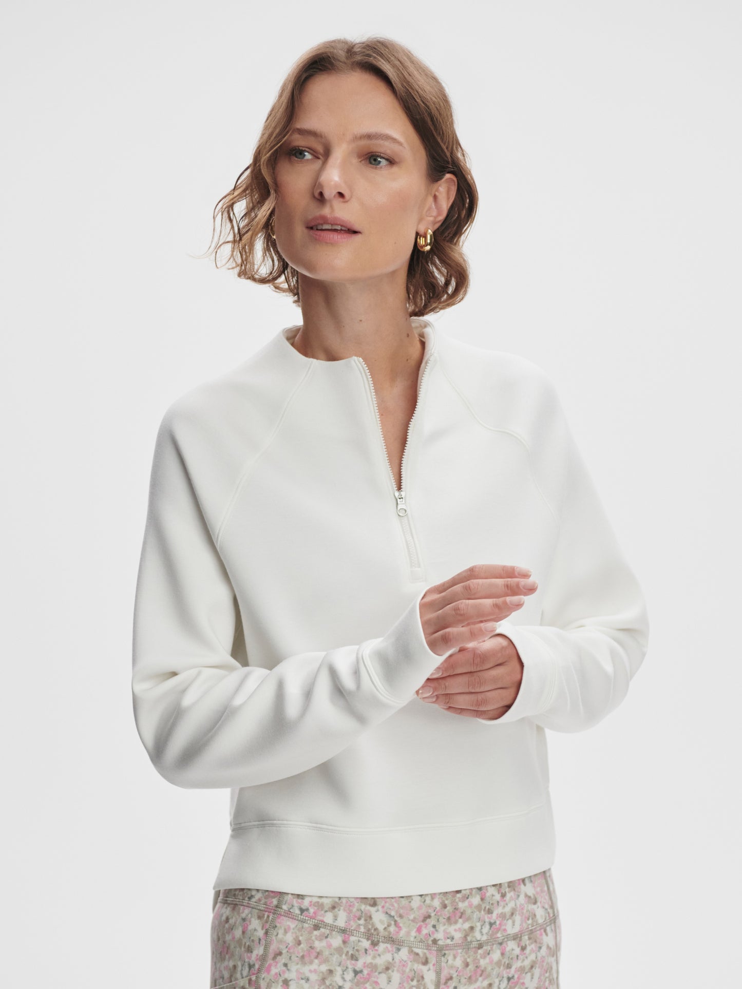 Model wearing Varley Ebba Halfzip MidLayer top in Snow White on TennisDuJour.com.