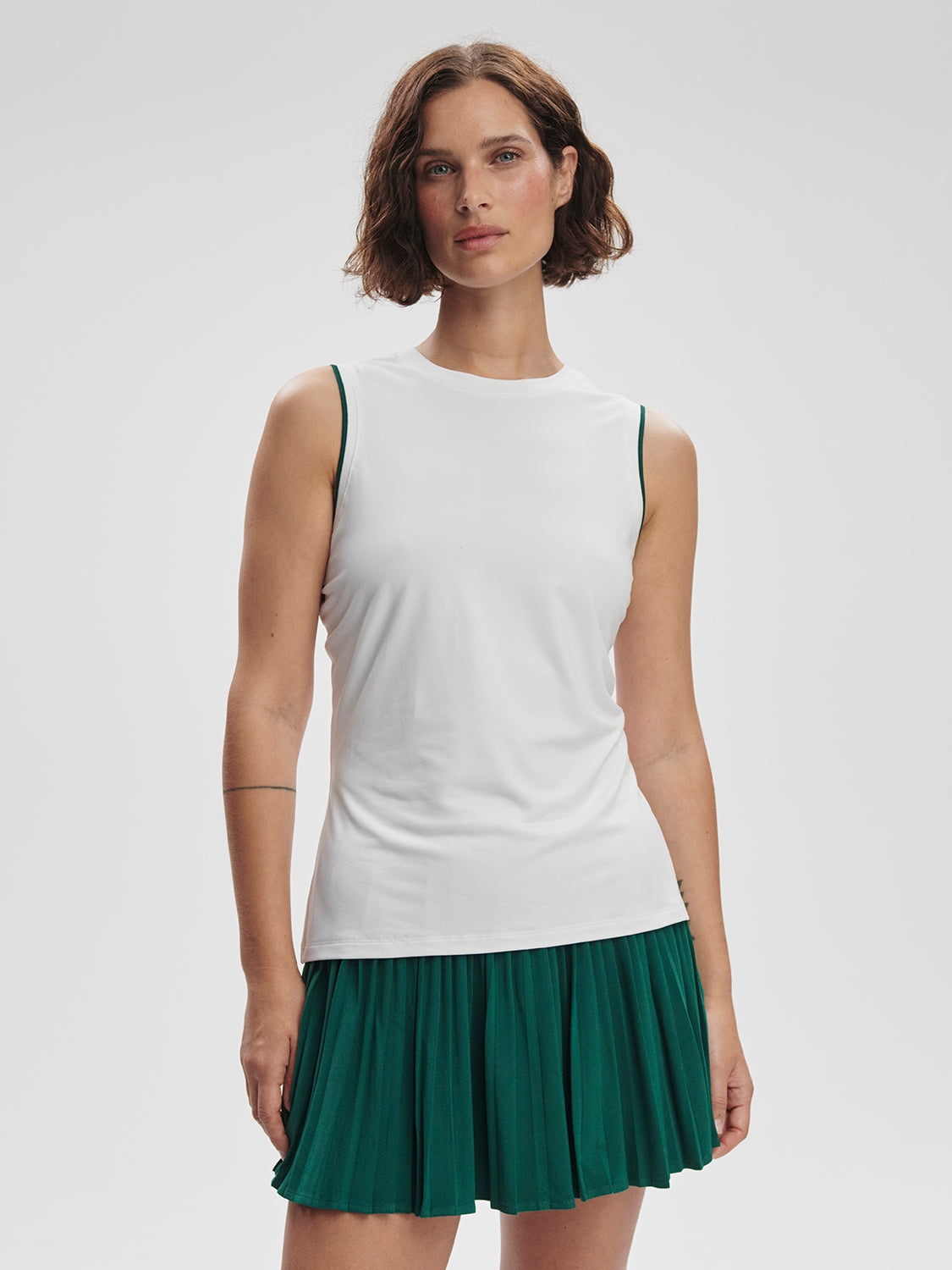 Model wearing Varley Arton Performance Tank in white on TennisDuJour.com.