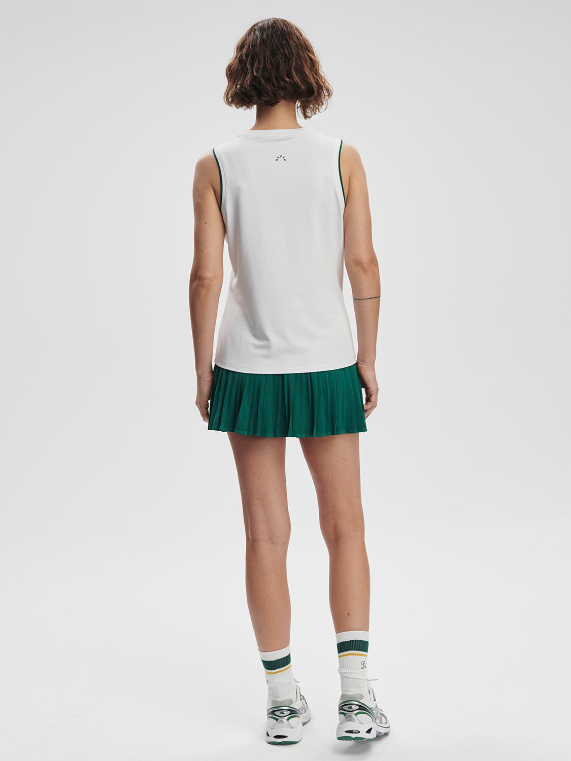 Model wearing Varley Arton Performance Tank in white on TennisDuJour.com.