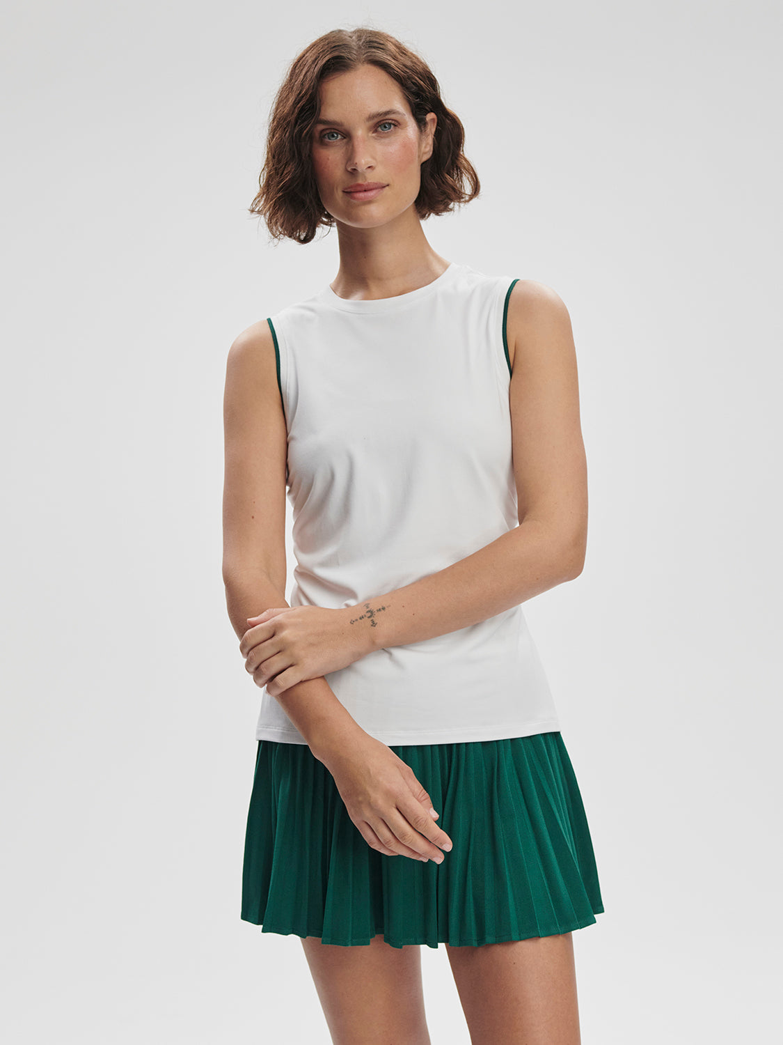 Model wearing Varley Arton Performance Tank in white on TennisDuJour.com.
