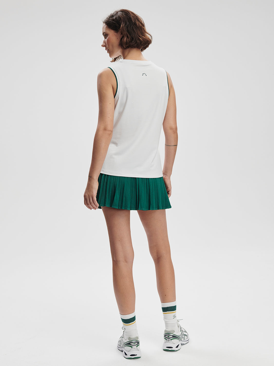 Model wearing Varley Arton Performance Tank in white on TennisDuJour.com.
