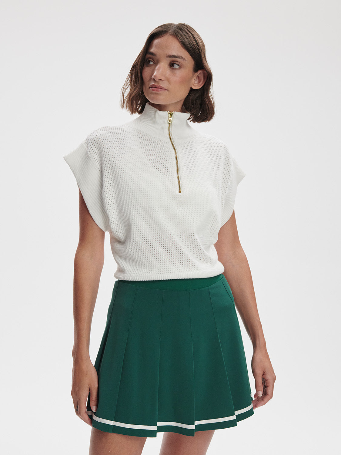 Model wearing Varley Clarendon Tennis Skirt in Forest green on TennisDuJour.com.