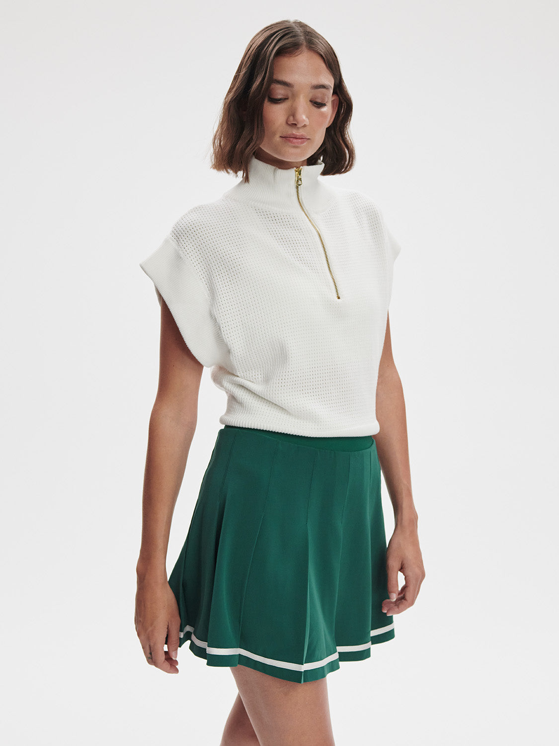 Model wearing Varley Clarendon Tennis Skirt in Forest green on TennisDuJour.com.