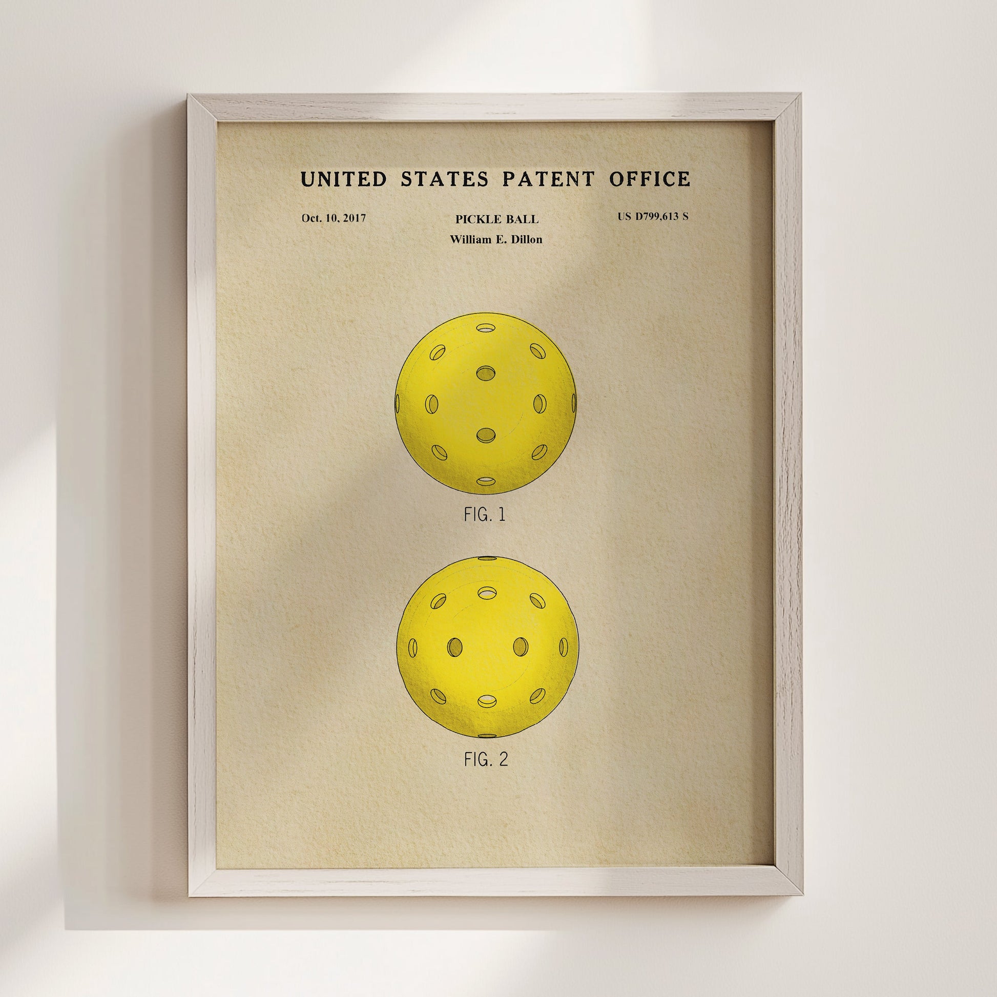 Framed print of a pickle ball design from the United States Patent Office on a beige background
