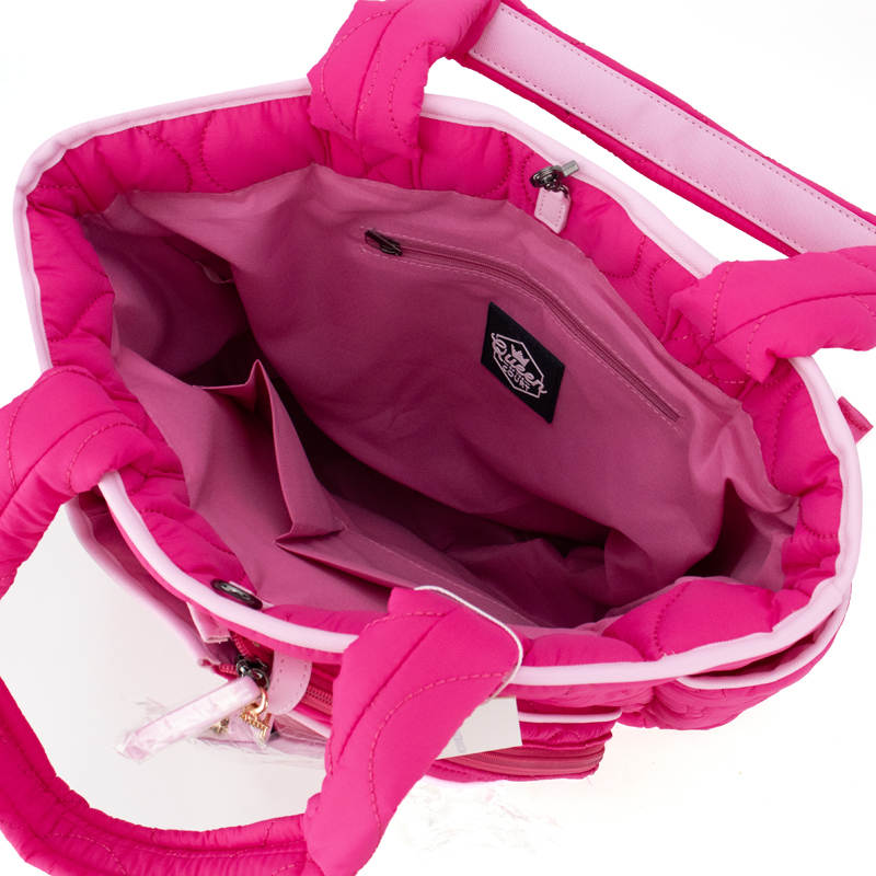 Close-up of a pink backpack with a brand logo on a white background