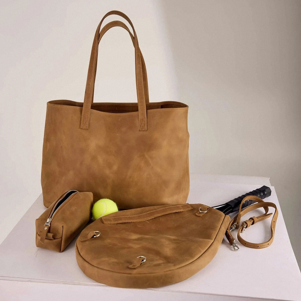 Genuine leather bag with removable tennis racket cover.
