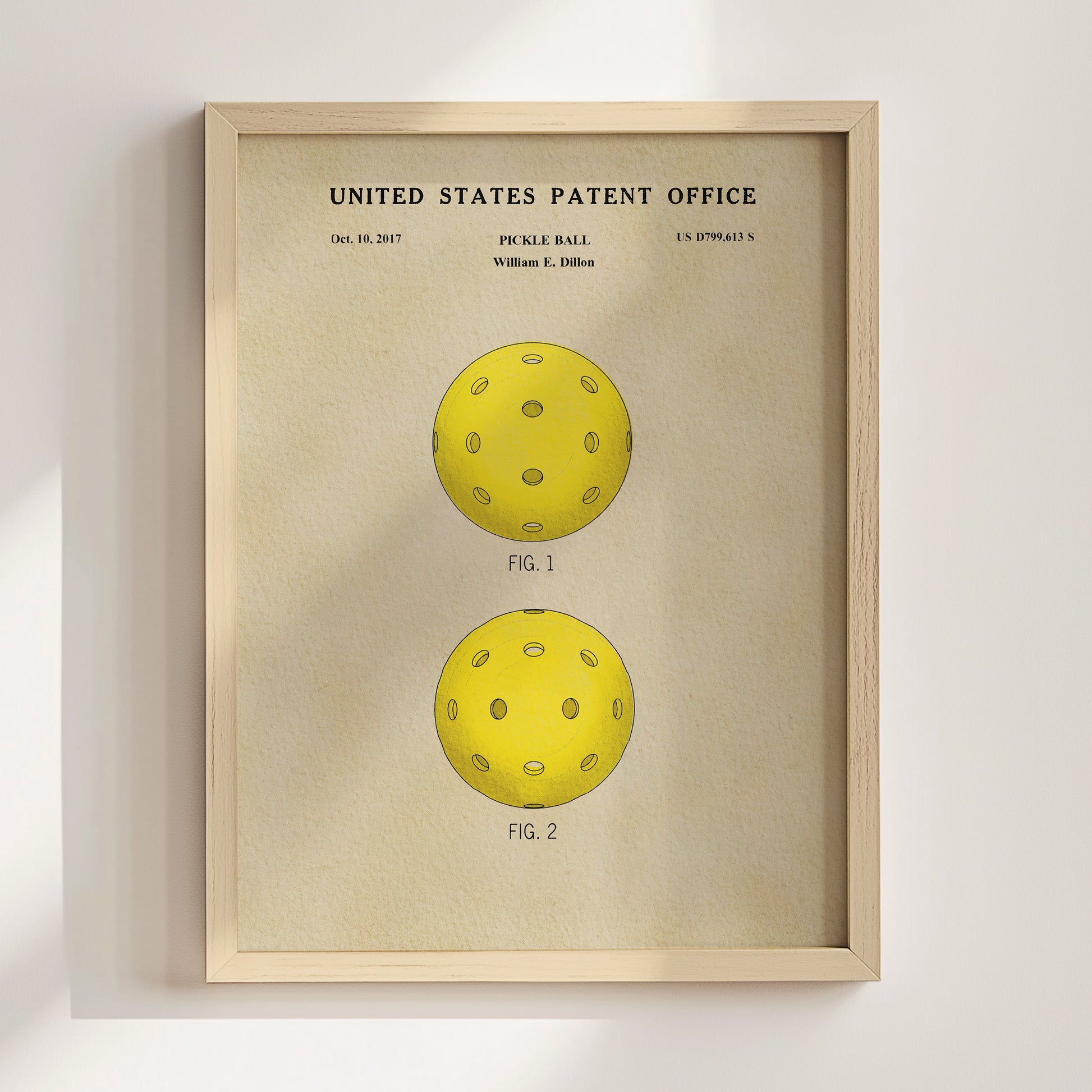 Framed poster of a pickle ball design from the United States Patent Office on a beige background.