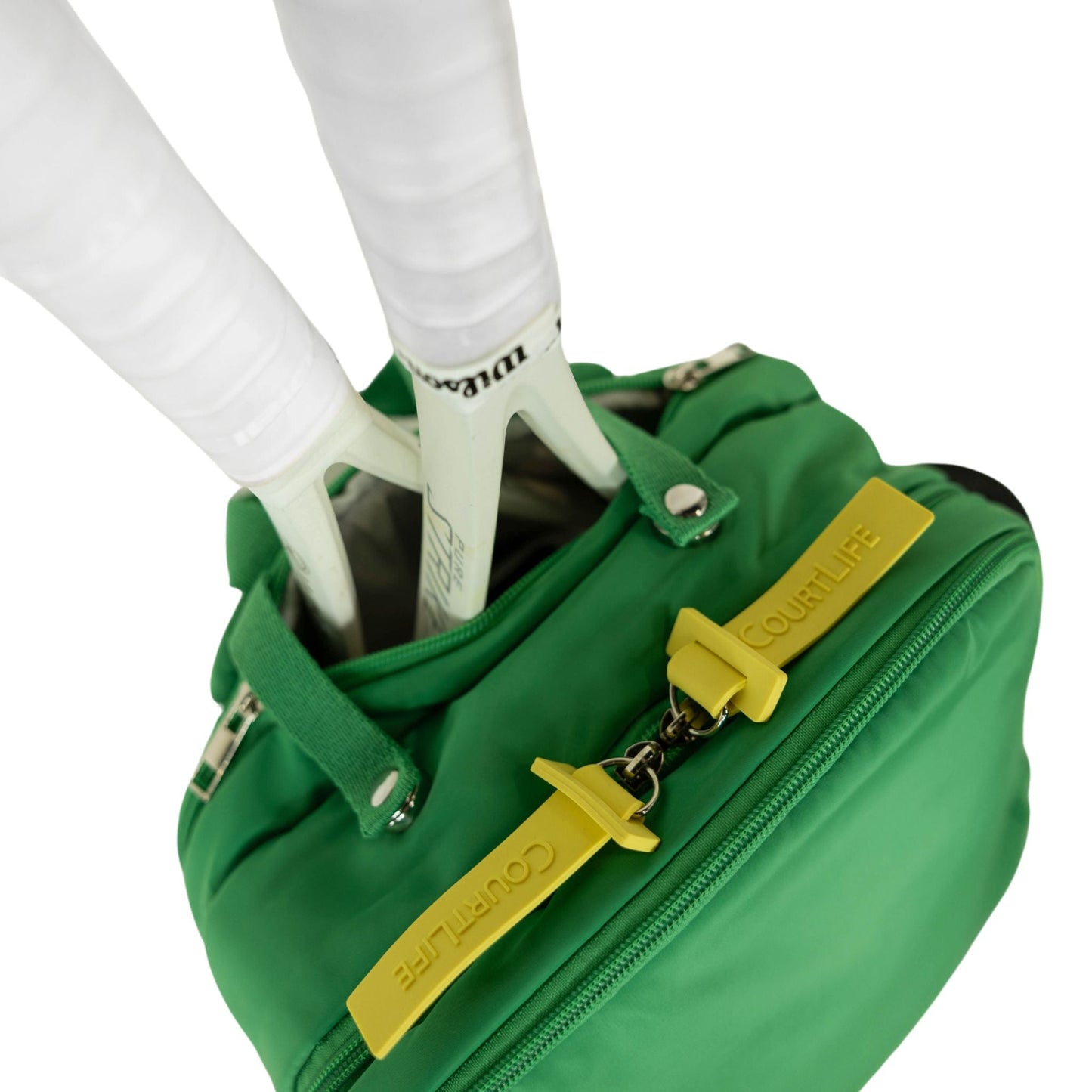 Green bag with yellow accents held by a person wearing white shoes on a white background