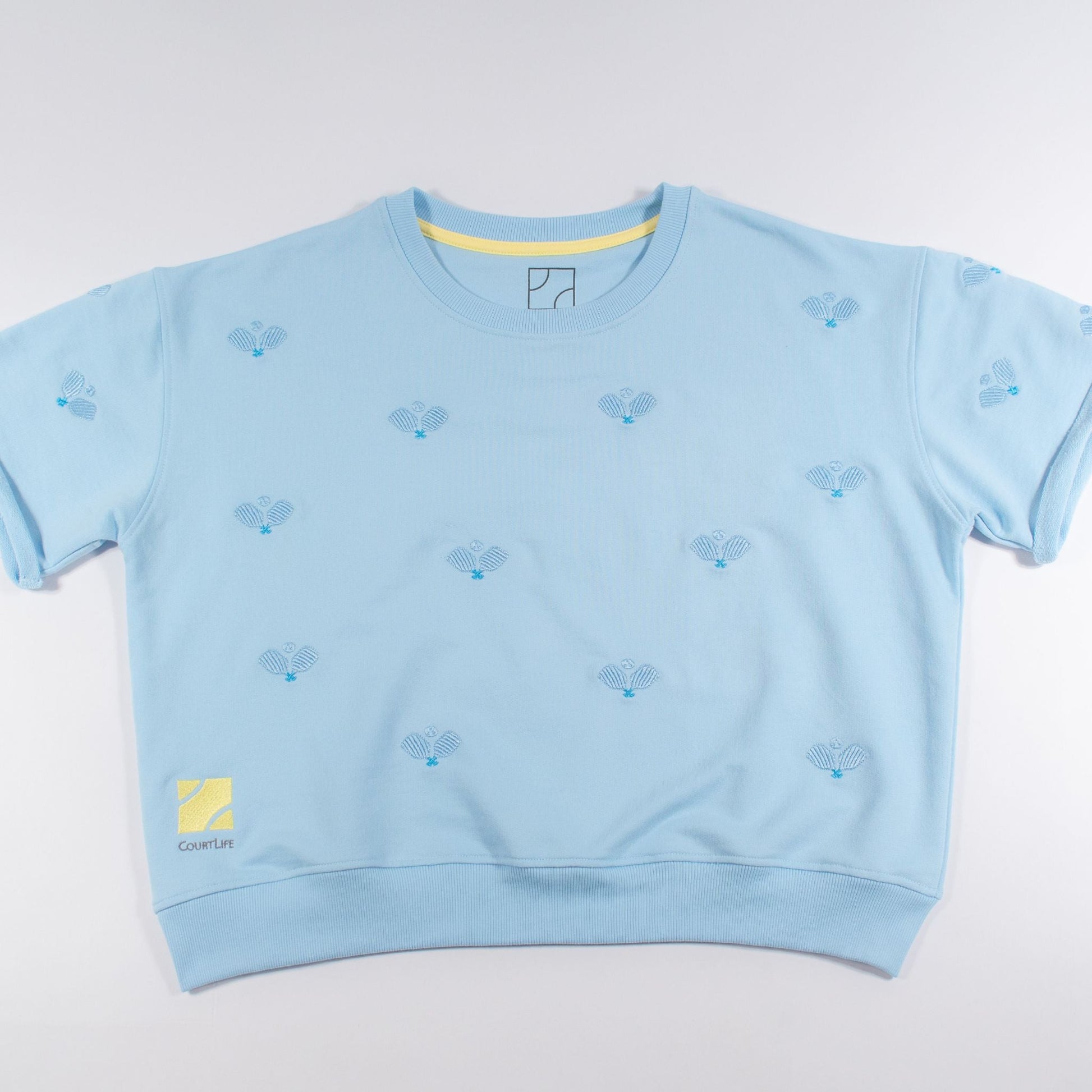 Light blue sweatshirt with small patterns on a light gray background