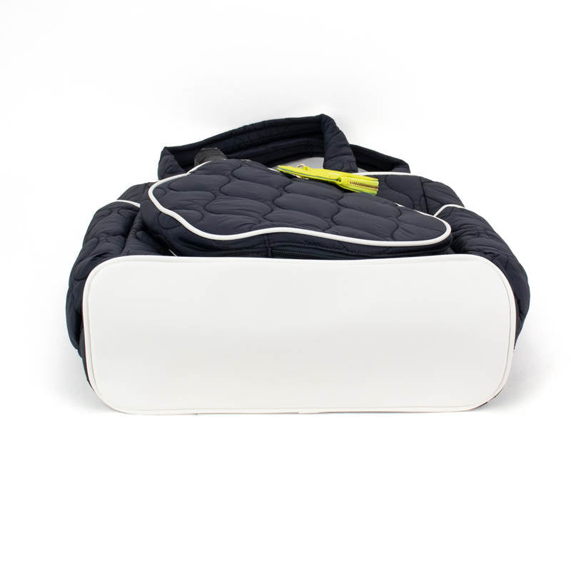 Black and white quilted bag with a yellow tag on a white background