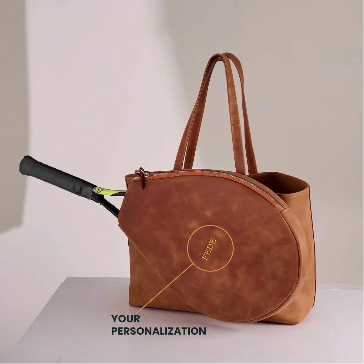 Genuine leather bag with removable tennis racket cover.