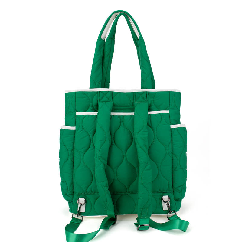Green quilted tennis  bag with multiple pockets and straps on a white background