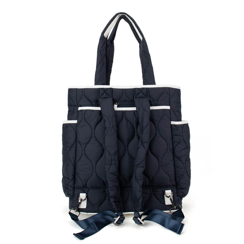 Navy quilted tennis bag with multiple pockets on a white background