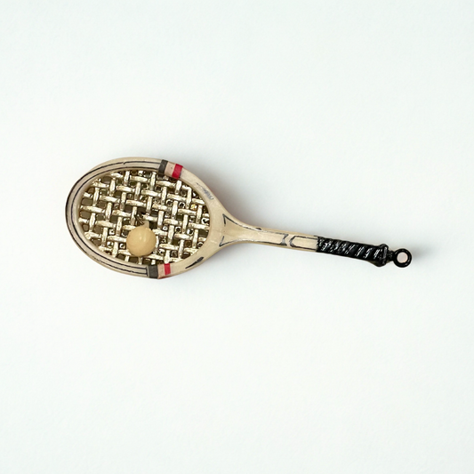 Vintage Annalee Mouse tennis racket ornament from the 1970s featuring a metal racquet, gold-tone strings, and a tiny attached ball.