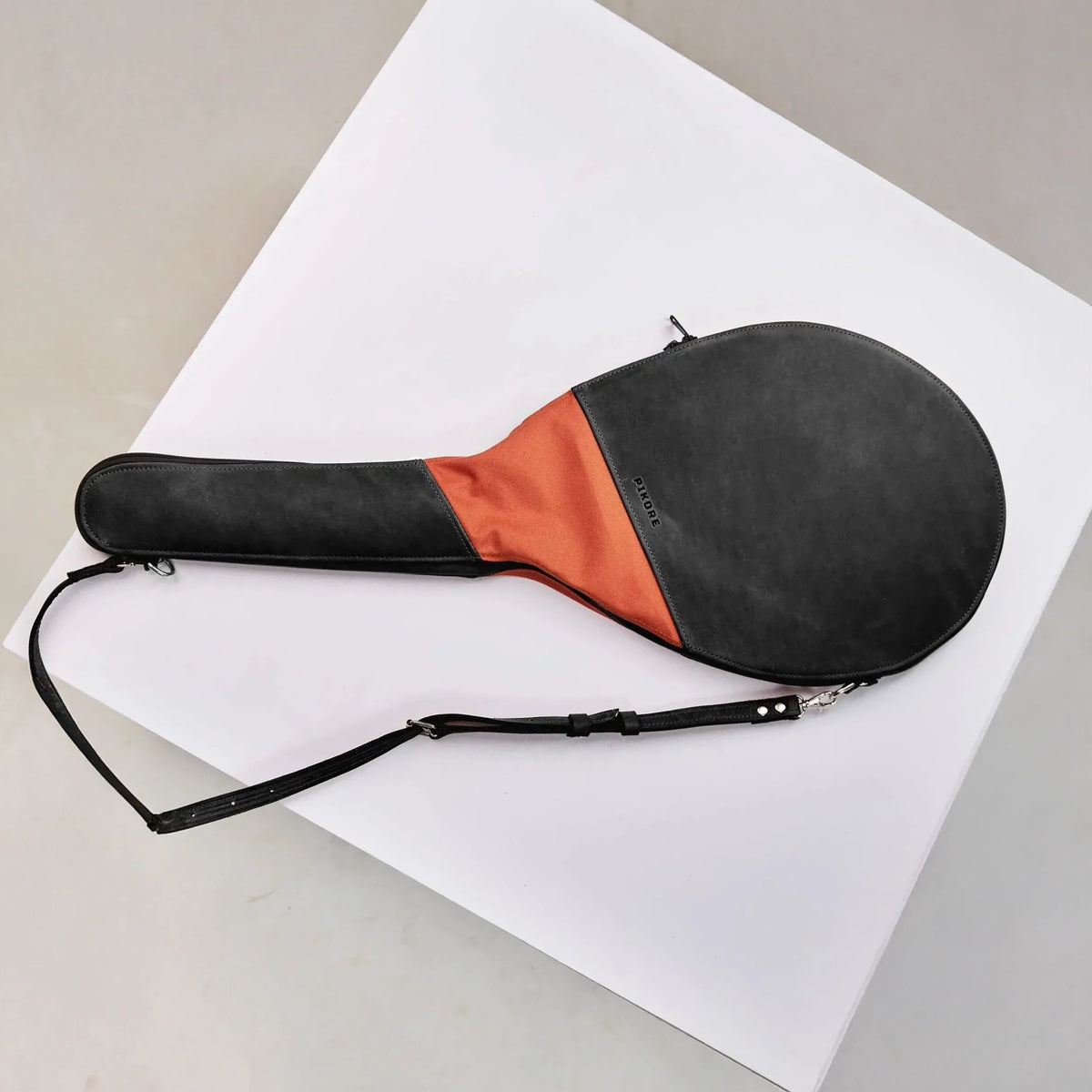 Black and brown tennis racquet cover.