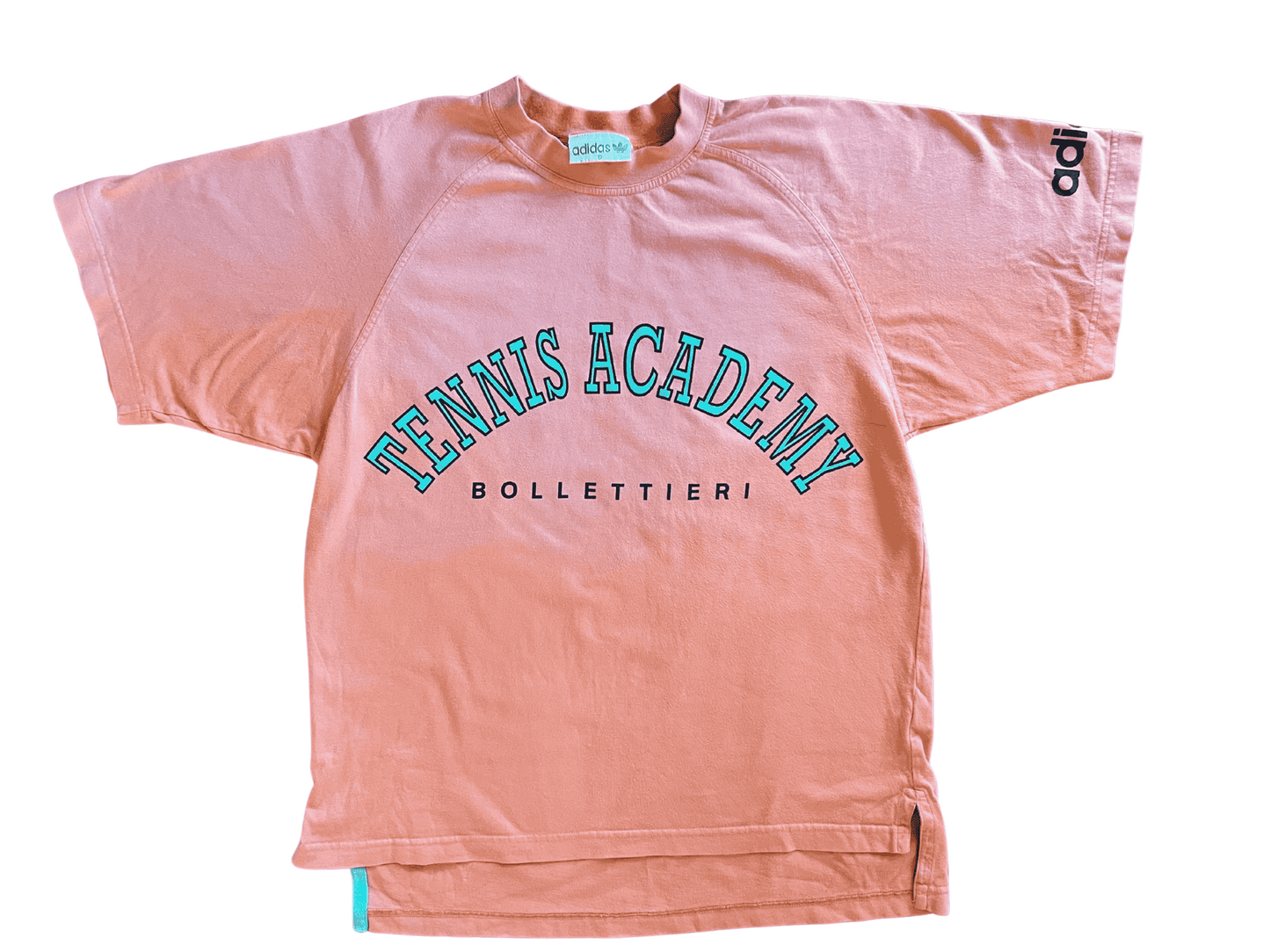 Pink athletic shorts with 'Bollettieri Tennis Academy' text and Adidas logo on a white background
