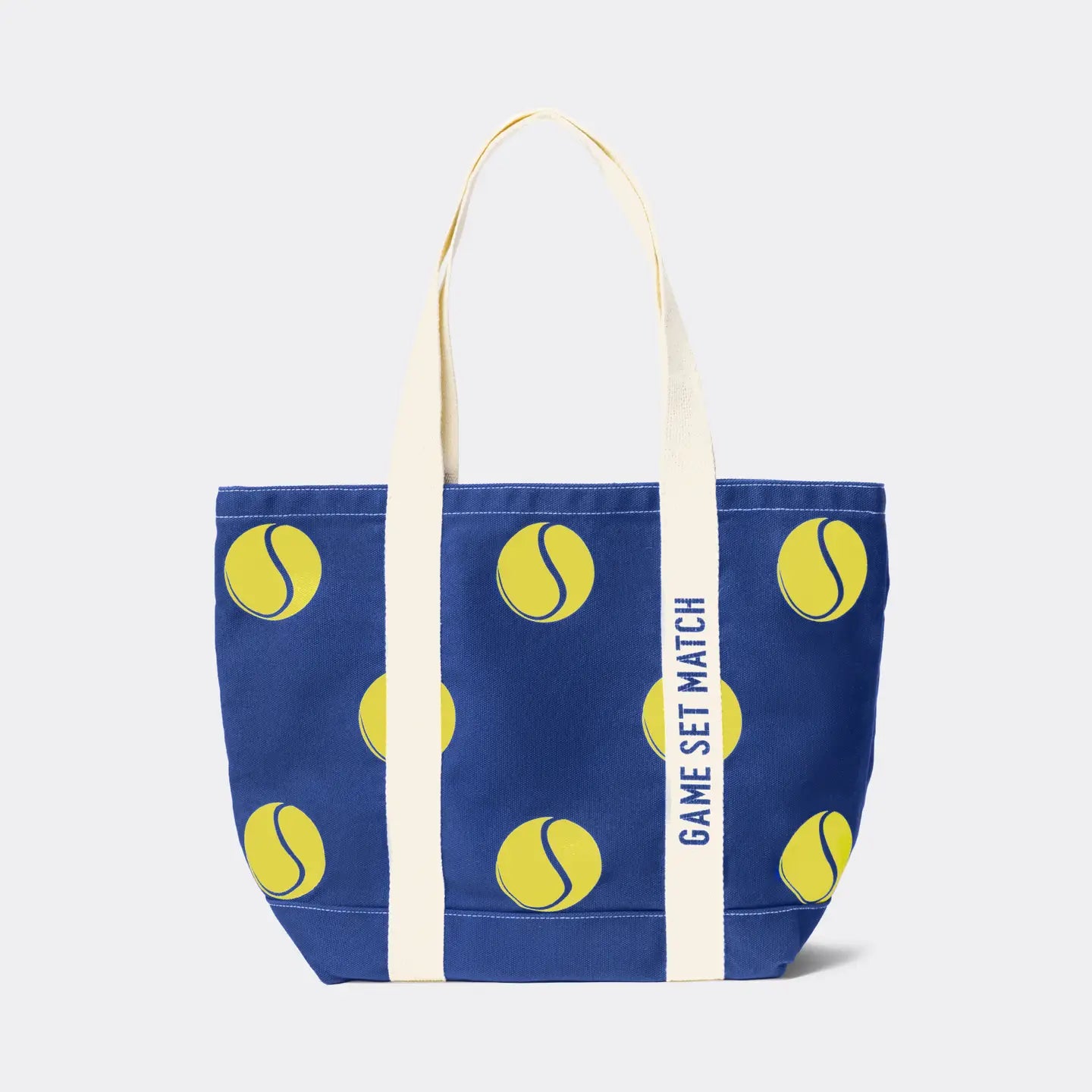 Blue tote bag with yellow tennis ball pattern and 'Game Set Match' text on a white background