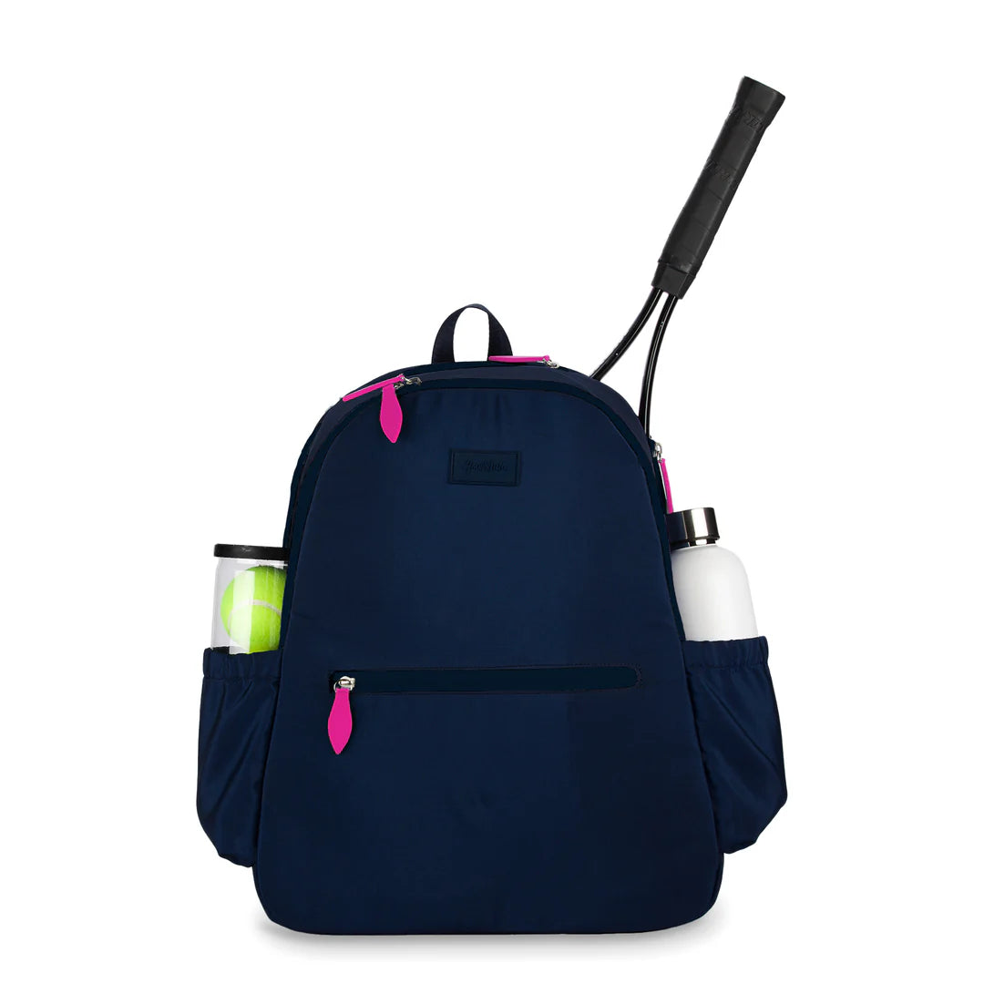 Navy blue Ame & Lulu Courtside tennis backpack with pink accents, holding a tennis racket, water bottle, and sports drink can on a white background.