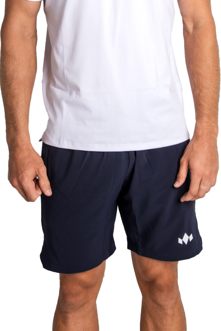 Person wearing navy shorts with a logo on a white background