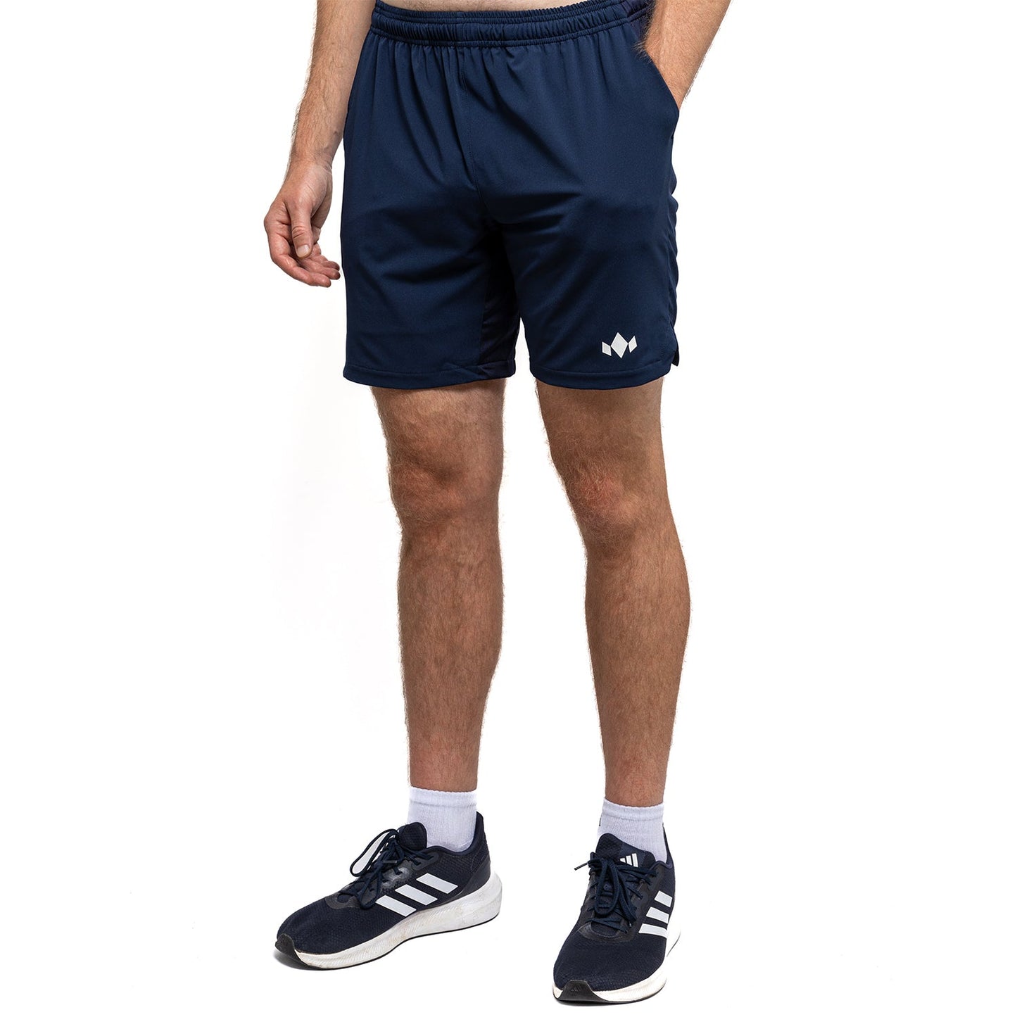 Person wearing navy shorts with a logo on a white background