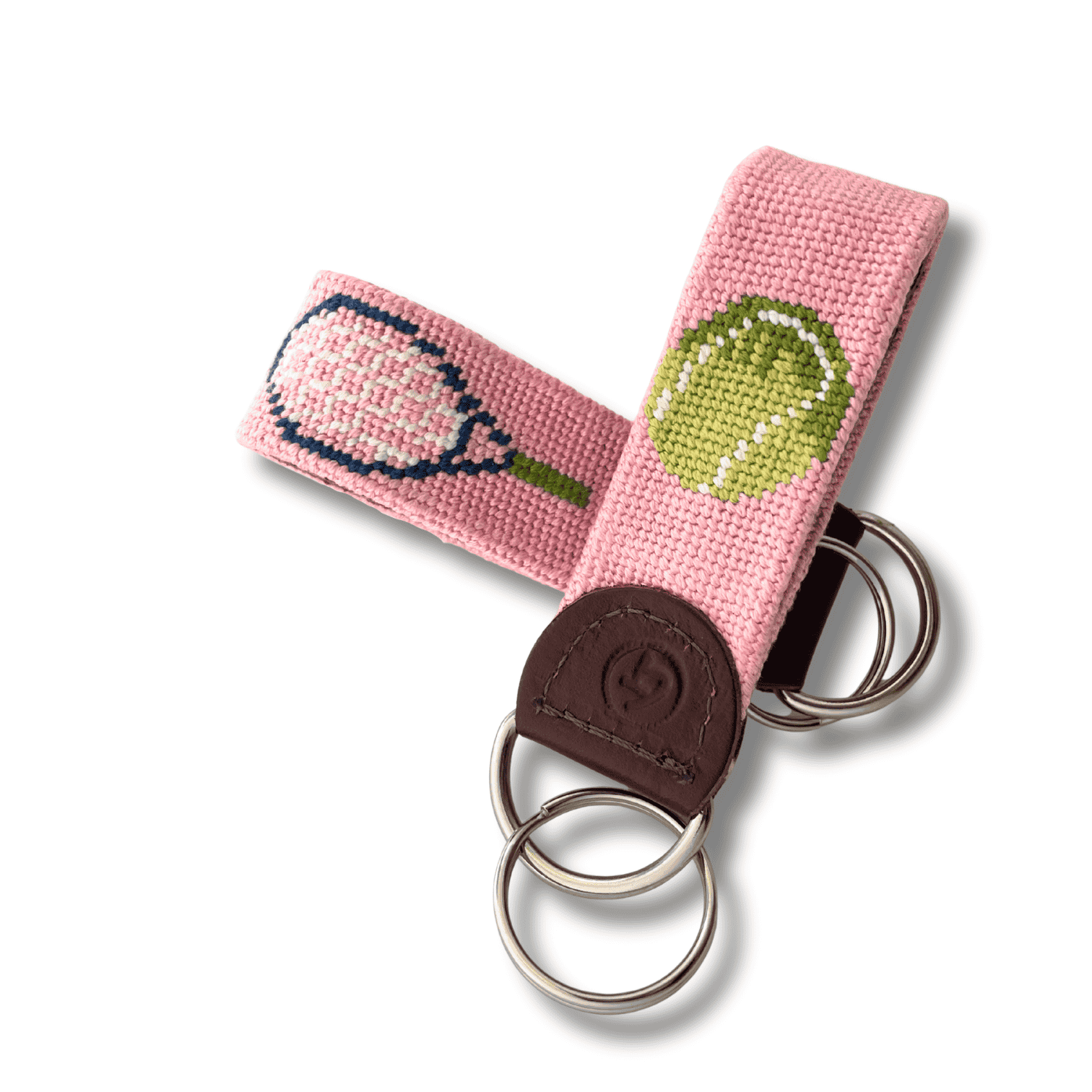 Keychain with tennis racket and ball design on a pink background