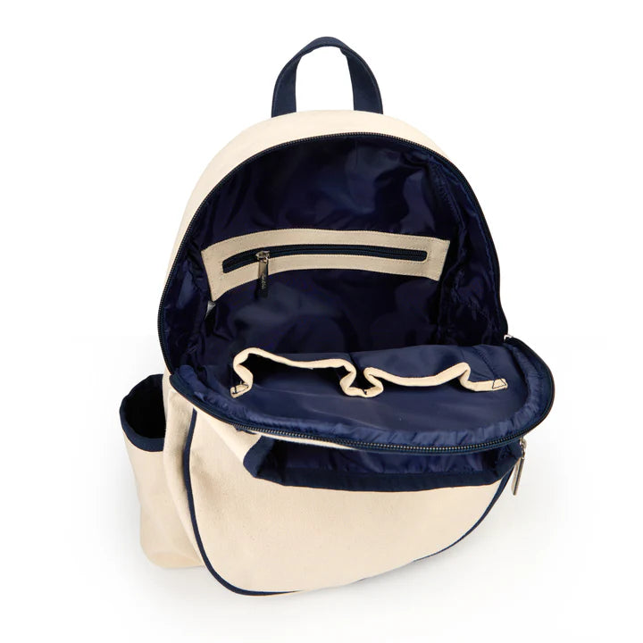 Two-tone backpack with cream exterior and navy interior on a white background