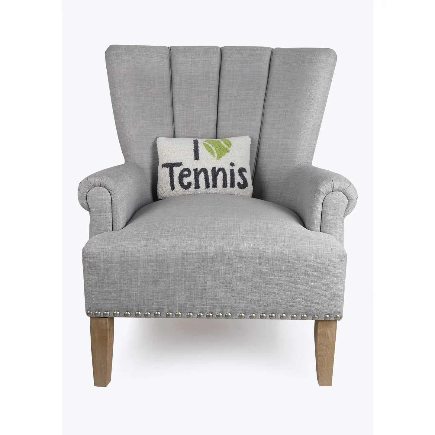 I love tennis hook pillow on gray chair on Tennis DuJour.