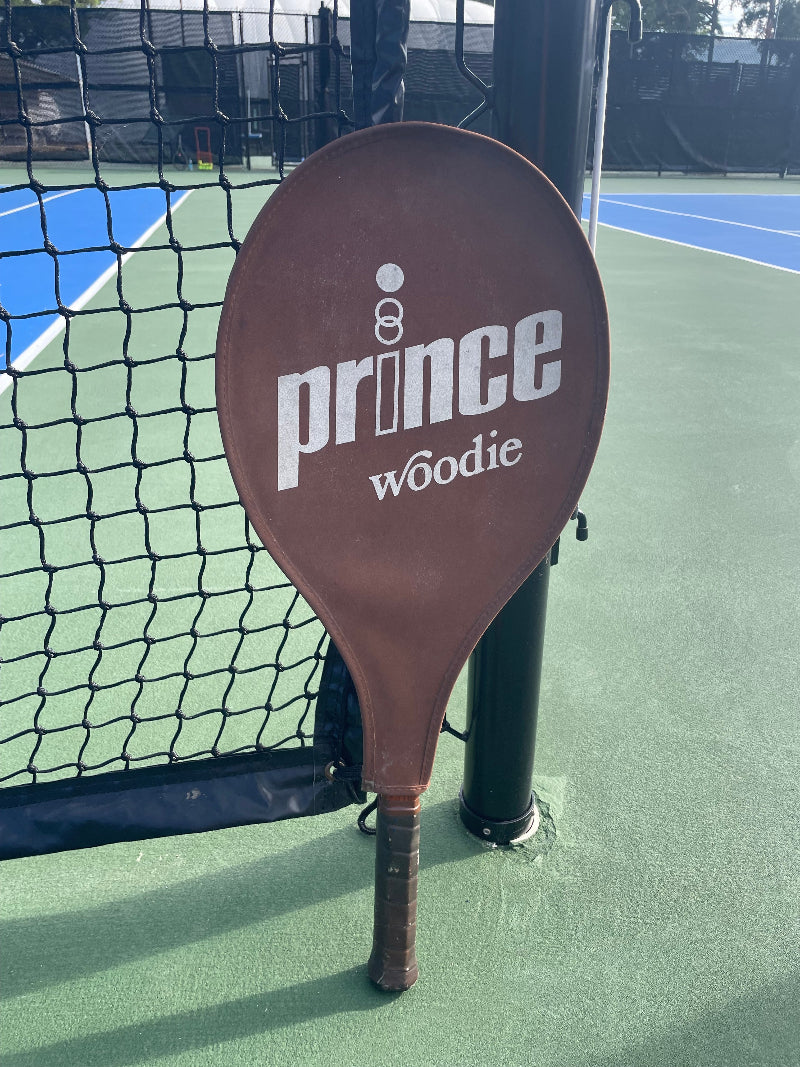 Brown Prince Woodies Tennis racquet on a tennis court
