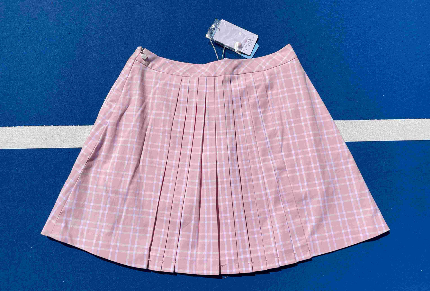 Lily's of Beverly Hills pink plaid skirt on a blue background