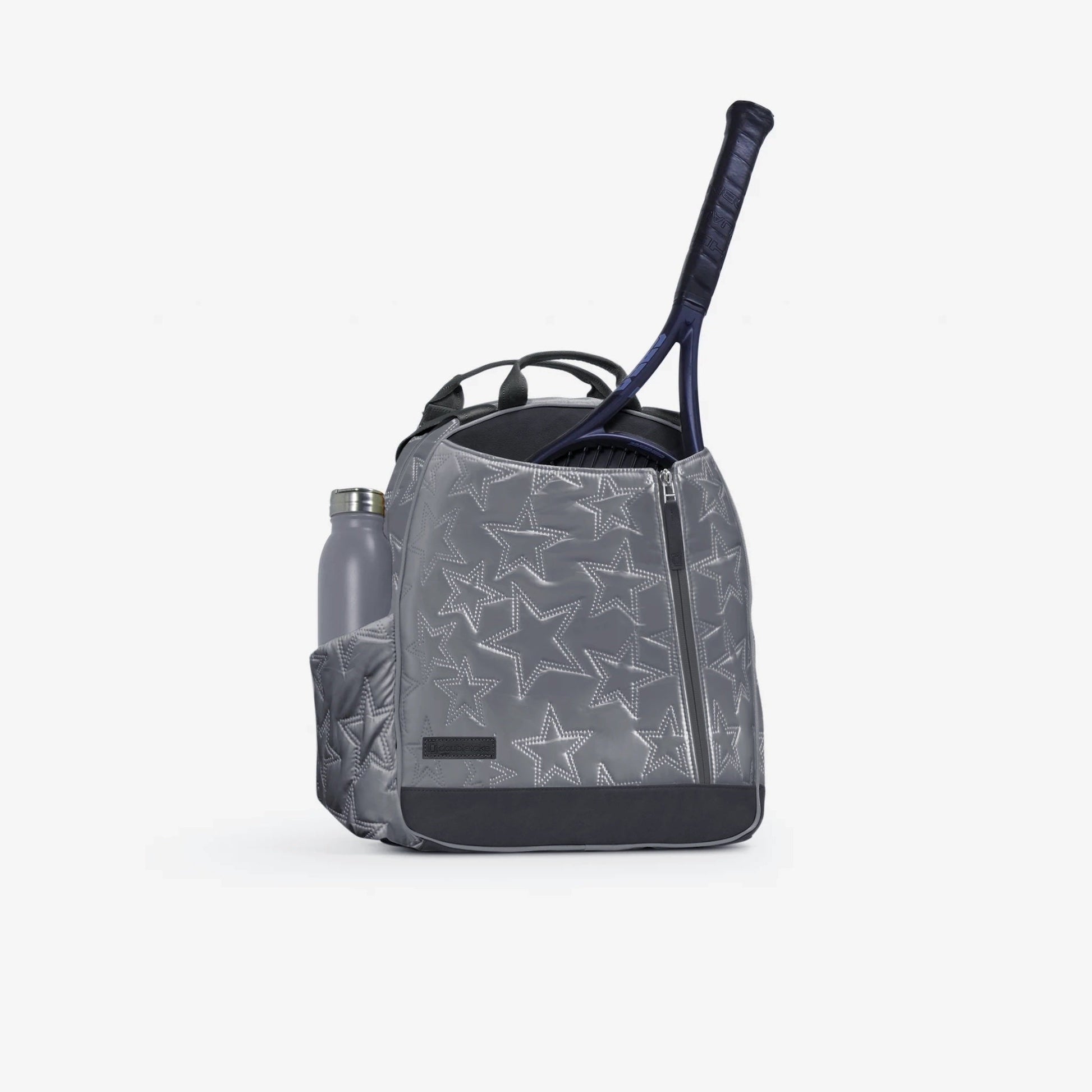 Gray Doubletake tennis backpack with star pattern, tennis racket, and water bottle on a white background