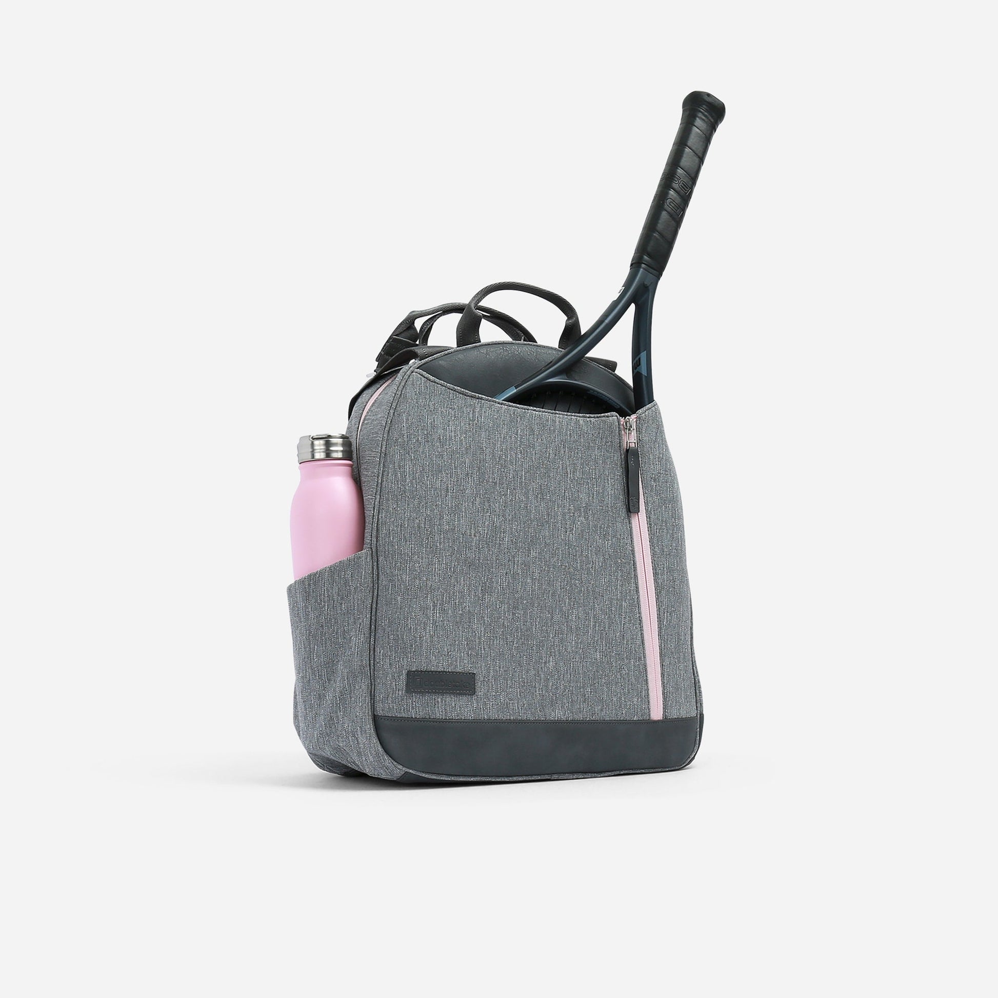 Gray Doubletake tennis backpack with pink water bottle and black handle on a white background