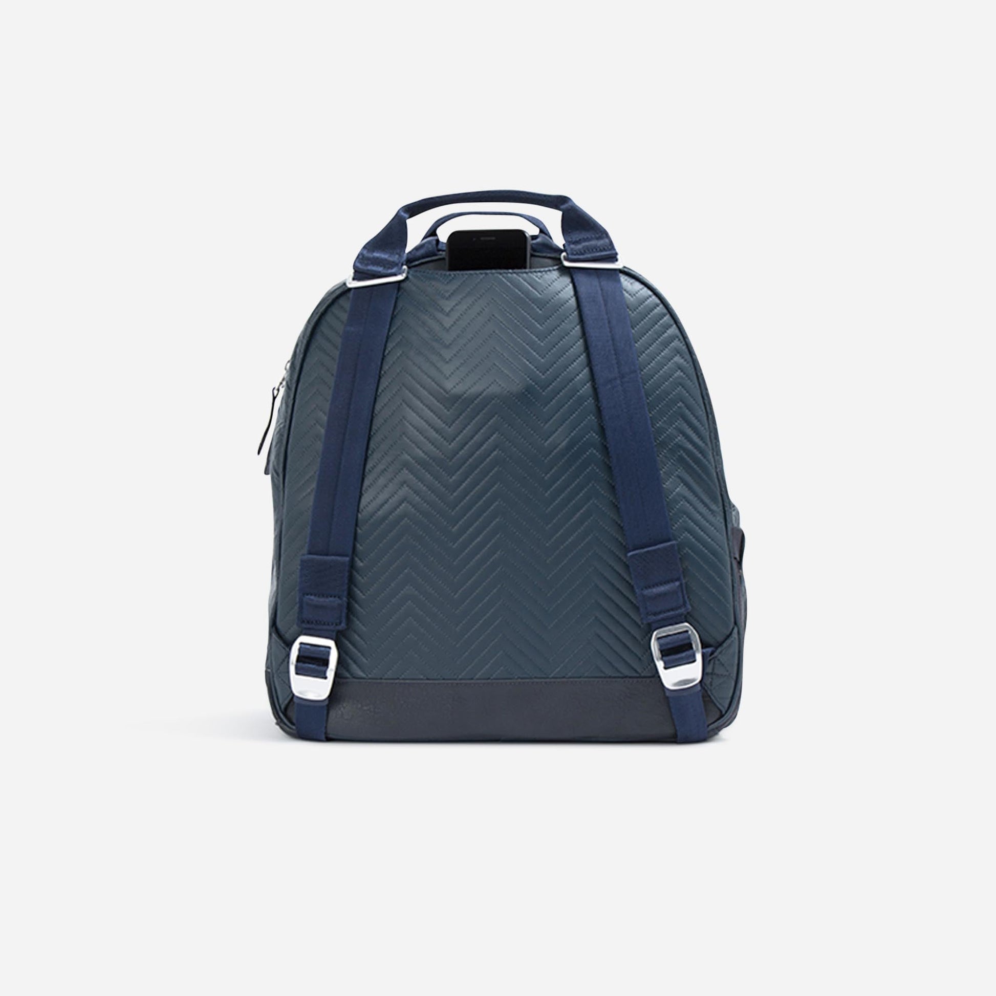 Green  Doubletake tennis backpack with blue straps on a light gray background