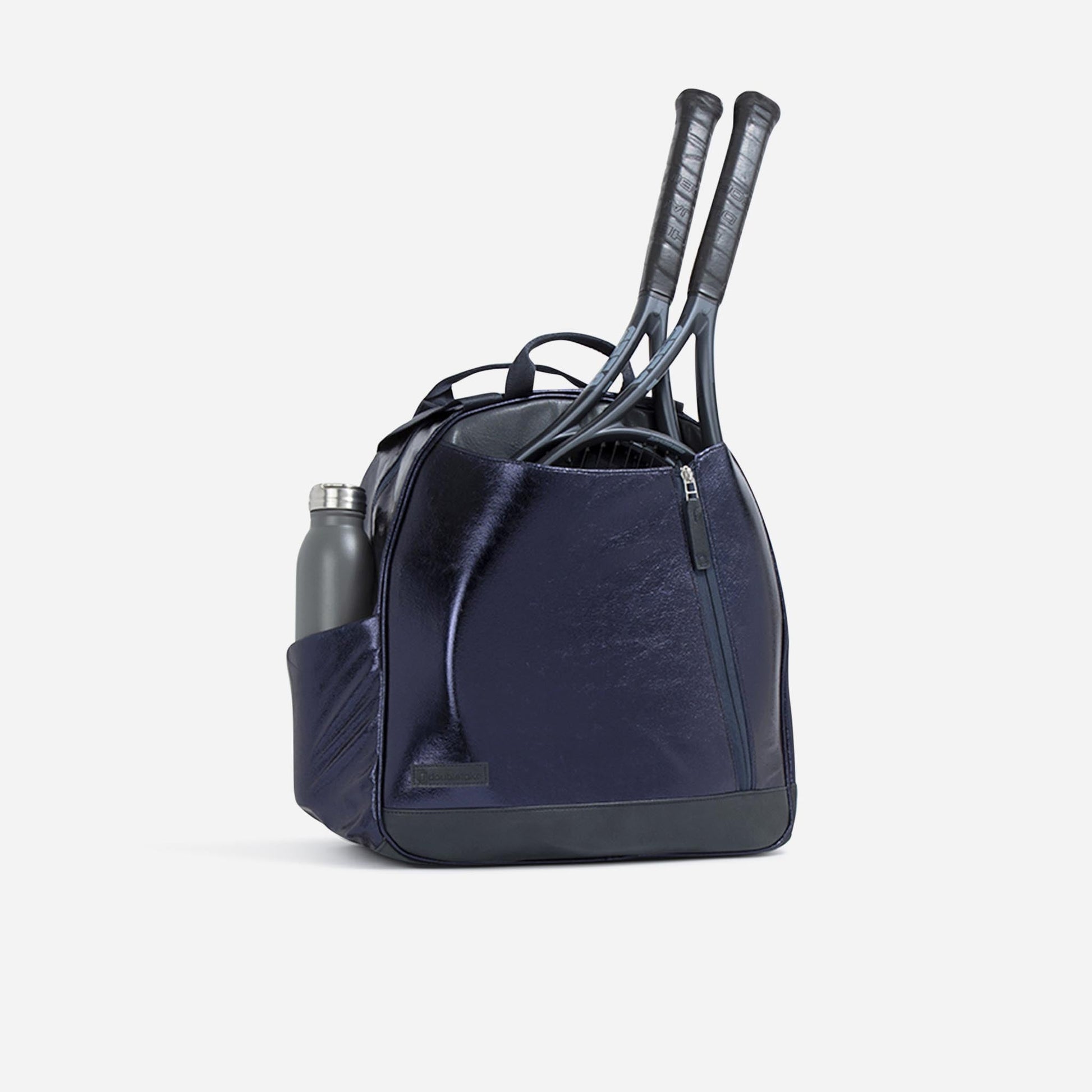 Navy blue  Doubletake tennis  backpack with tennis rackets and a water bottle on a light gray background