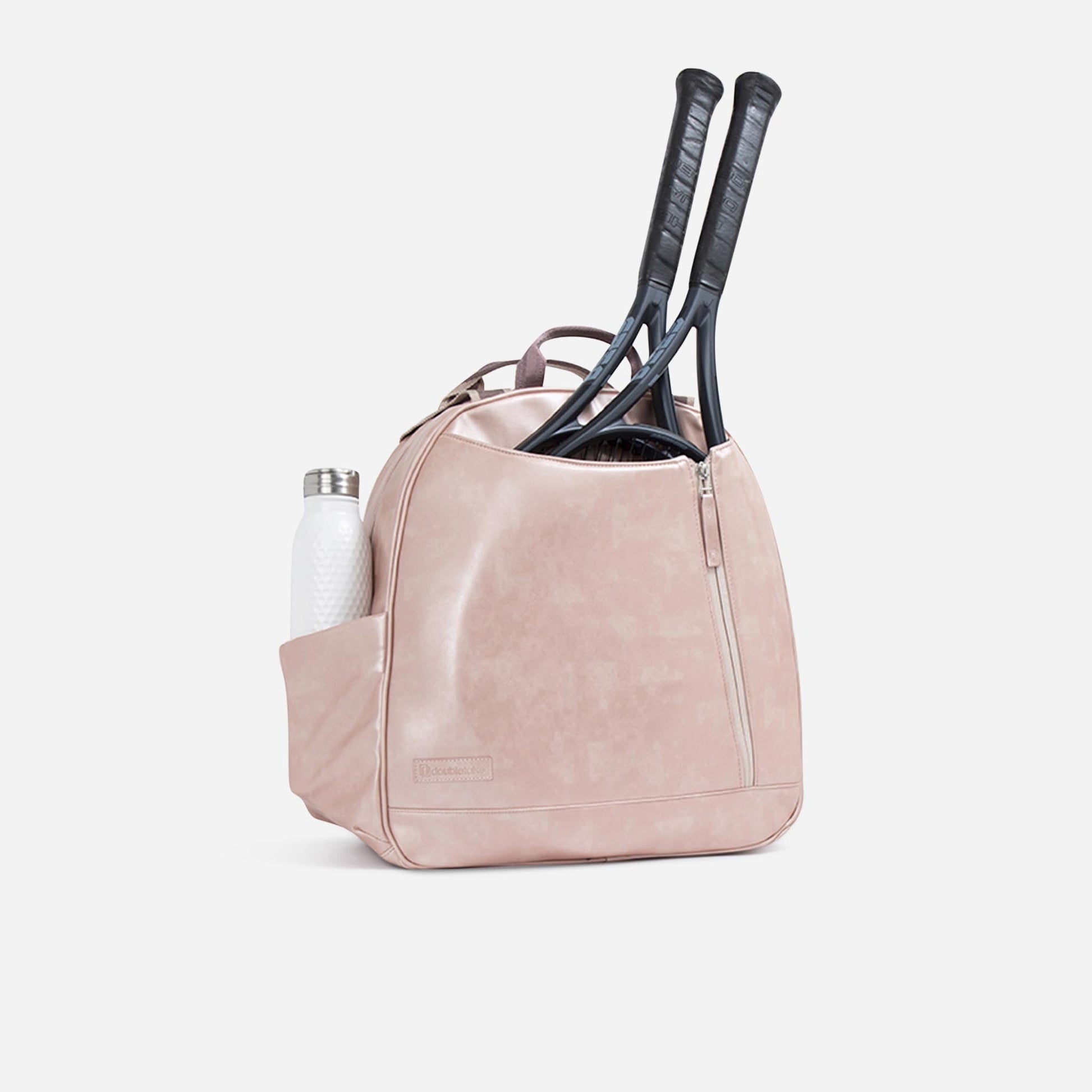Pink tennis  Doubletake tennis bag with two rackets and a bottle on a white background