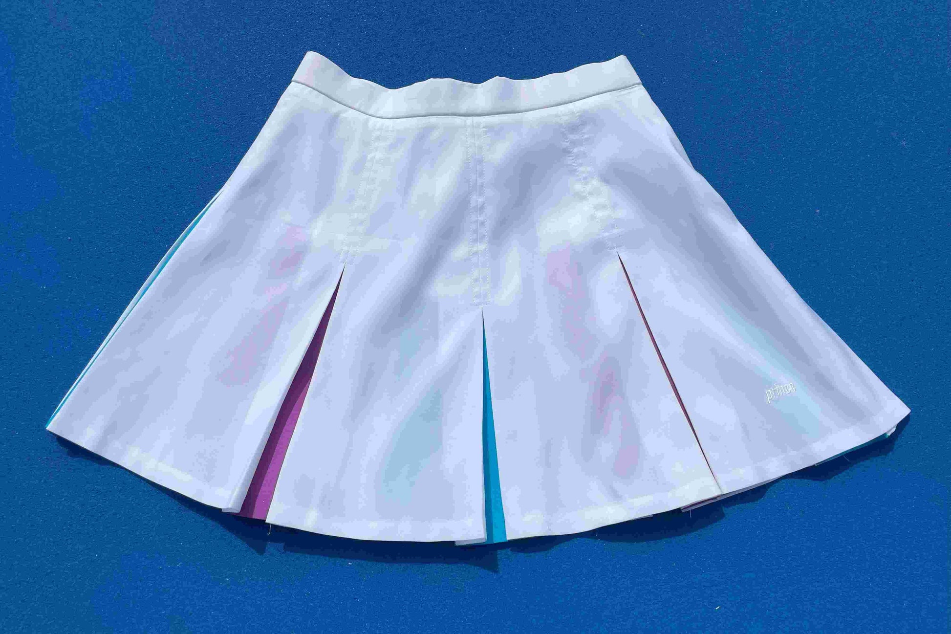 Prince White skirt with colorful abstract patterns on a blue background